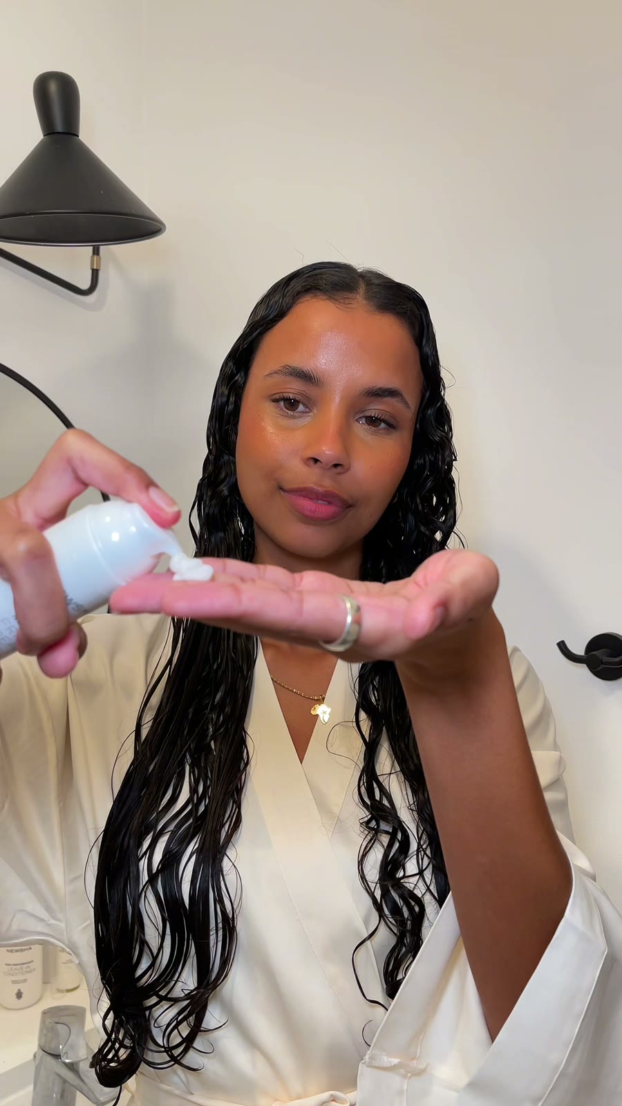 Melanie showing how to use a hair product